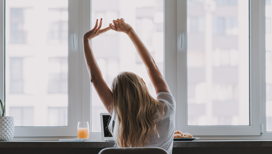 woman stretching while working from home