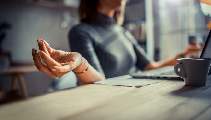 employee meditating at desk