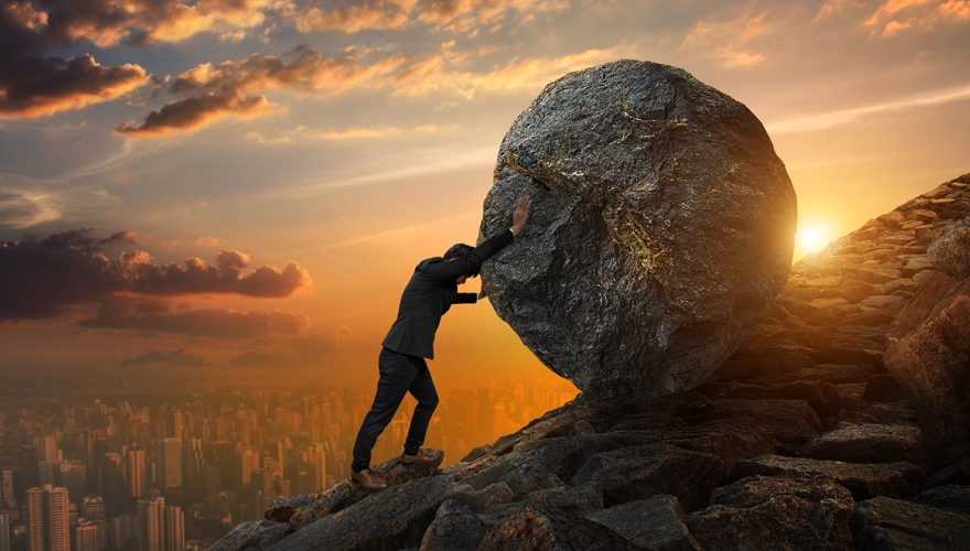 business man pushing a boulder