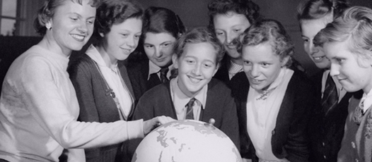 Children looking at a globe: How to localise your content without losing your voice