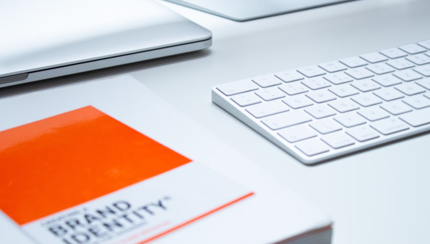 brand identity notebook beside laptop