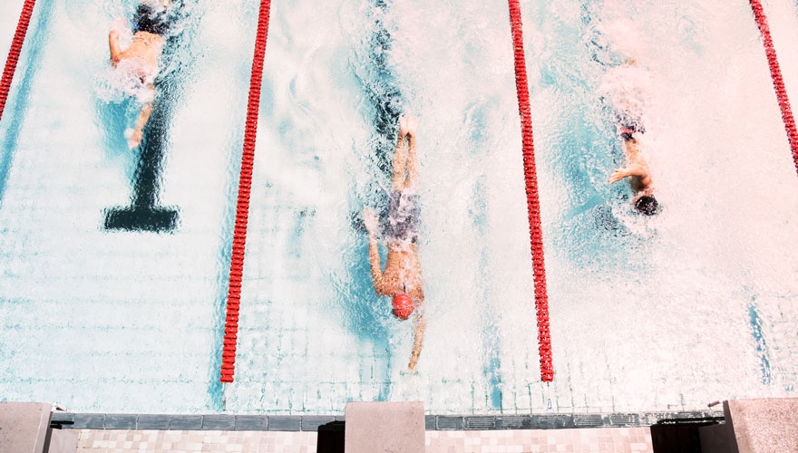 Swimmers racing in pool